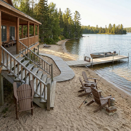 All-weather poly folding adirondack chairs pictured at lakeside fishing resort.