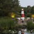 Amish crafted poly garden lighthouse, Montauk, NY model, in black, cherrywood, white, pictured by patio.
