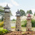 Amish crafted stone garden lighthouses in flower garden.