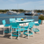Amish crafted outdoor furniture, poly surfboard table and chairs set in aruba blue and white, overlooking water at yacht club.