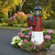 Poly lighthouse with mailbox, amish crafted, pictured in flowerbed beside road.