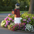 Poly lighthouse with mailbox, amish crafted, pictured in flowerbed beside road.