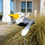 Amish handcrafted lawn decor whirlygig garden stake - Pelican, pictured in beach house flower bed