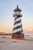AZEK® PVC Cape Hatteras replica garden lighthouse, Amish crafted, 4 foot with base. Pictured on beach at sunset.