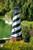 Cape Hatteras replica AZEK® PVC garden lighthouse, 6 foot with base, pictured on pond bank.