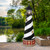 AZEK® PVC Cape Hatteras replica garden lighthouse, Amish crafted, 5 foot with base, interior lighting. Pictured on waterfront patio.
