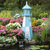 Amish crafted Cape Henry style premium poly garden lighthouse pictured in powder blue and white, in a flower bed by a koi pond