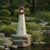 Amish made Cape May replica poly garden lighthouse pictured in rock garden beside koi pond.