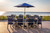 Beach scene Ocean Wavz dining chairs and Surf Aira surf board table setting, pictured in patriot blue and light gray.