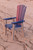 Amish crafted Ocean Wavz collection poly dining chair pictured on  the beach in patriot blue and light gray.