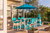 Surf-Aira 8 foot poly dining table and chair set pictured in aruba blue and white, in a deck setting.