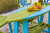 Surf-Aira 6 foot poly bar table in lime green and aruba blue, close up.