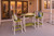 Surf-Aira Amish crafted poly outdoor bar table and chair set pictured in lime green and white on a patio.