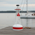 Amish crafted nautical lawn decor, ornamental buoy in white with red trim.