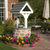 Amish handcrafted stone and poly wishing well, size small, white frame with dark gray, gray stone with gray grout. Pictured in flower bed on patio