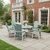 Amish built poly outdoor furniture, 43" dining table and 4 chairs set, seashell and mint, on patio of brick mansion