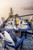 SummerSide poly dining height fire table by Finch, pictured on a dock