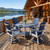Poly Amish built outdoor dining set in patriot blue and light gray, pictured on a lodge deck.