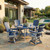 Poly Amish built outdoor dining set in patriot blue and light gray, pictured on a stone patio