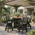 Poly bar height table and chairs under pergola of an upscale home. Pictured in black and coastal gray.