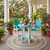 All-weather poly bar chairs and table on southern mansion veranda in summertime.