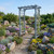 Morgan cedar arbor with gray stain pictured in rock garden