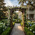 Cambridge cedar arbor pictured with walnut stain, in a southern mansion garden setting