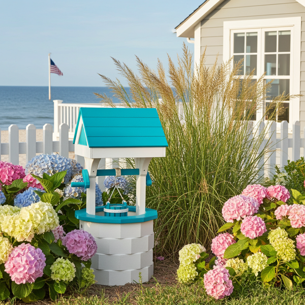 Amish crafted poly wishing well in white and aruba blue pictured in beach house flower bed