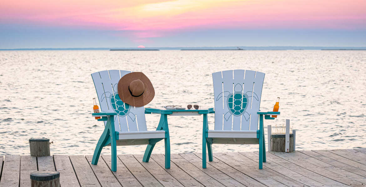 Amish made poly outdoor chairs on a dock at sunset