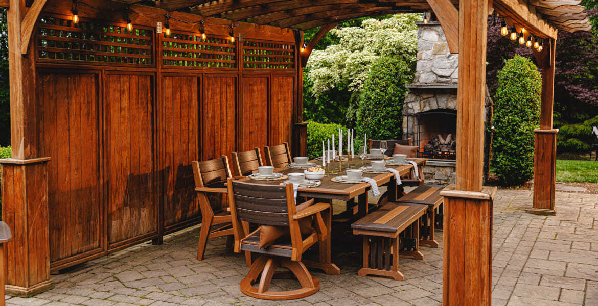 Amish crafted poly outdoor dining set on patio with pergola and fireplace