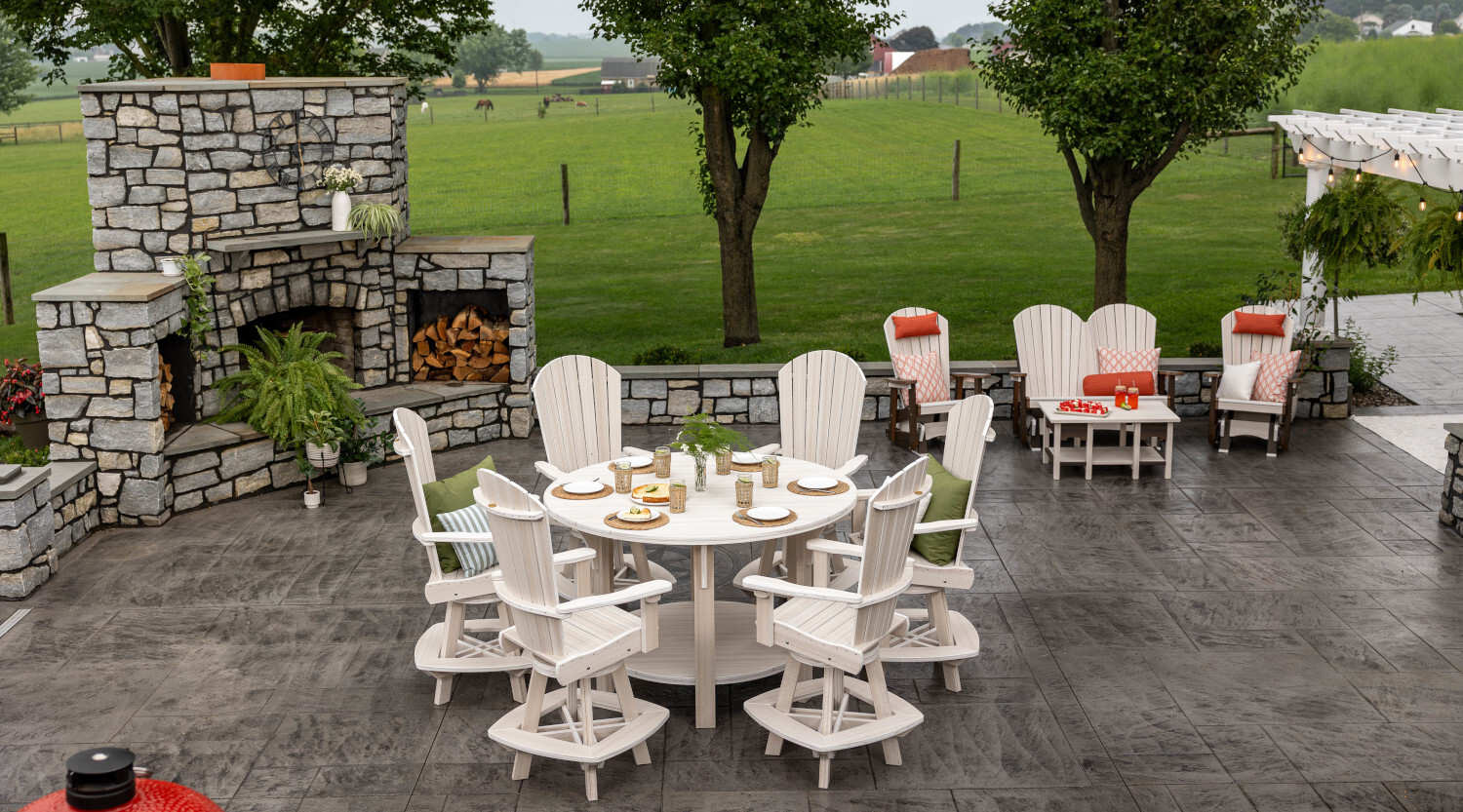 Amish crafted poly patio furniture made in America, pictured on stone patio with horses in pasture in background
