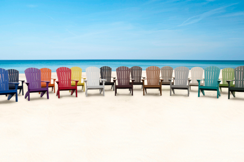 26 colors of poly adirondack chairs lined up on the beach
