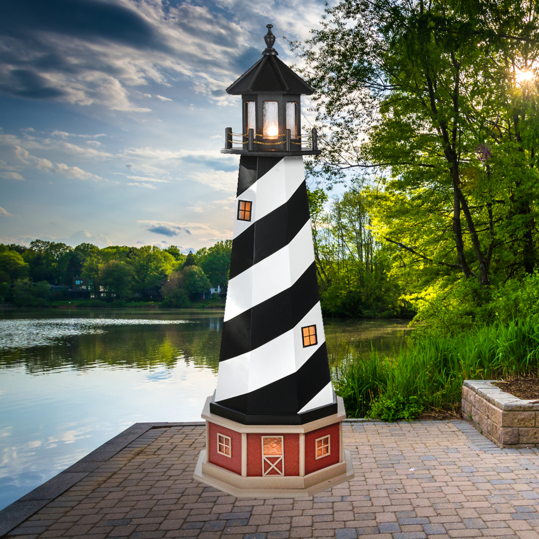 PVC Amish crafted garden lighthouse sitting on waterfront brick patio sunset & trees background