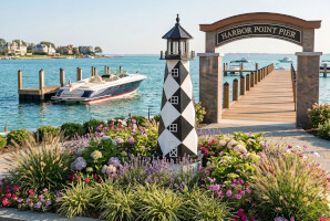 Wood garden lightouse pictured at entrance to pier