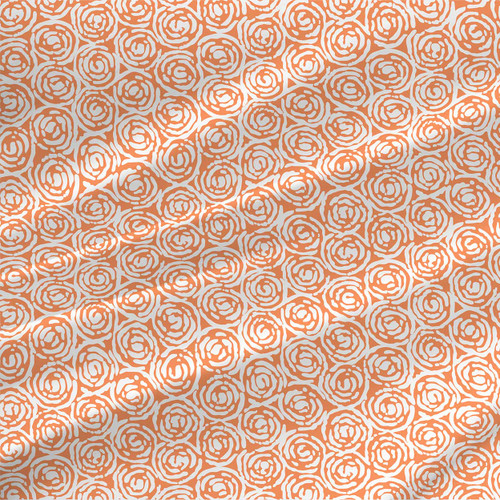 Whirlpool Mini Cantaloupe abstract floral fabric with orange spiral rosettes on a pale blue background.
