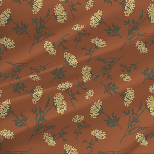 Queen Anns Lace fabric with pale yellow clustered blooms and dark green stems on a cinnamon background