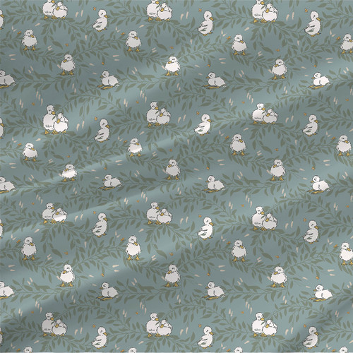 Ducklings and Butterflies fabric with white ducklings, soft green foliage, pale peach details, and tiny butterflies on a blue-green background