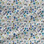 Wild Meadow Ocean floral fabric with blue and teal wildflowers, soft yellow-green accents, delicate leaves, and fine botanical linework.