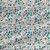Wild Meadow Bay Breeze floral fabric with teal and blue wildflowers, fine botanical linework, scattered leaves, and soft multicolor accents.