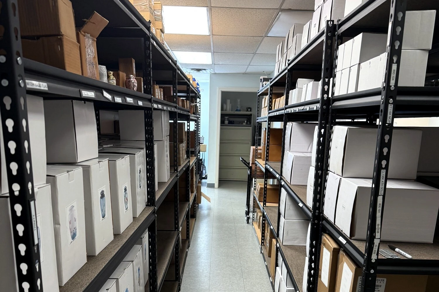 Turner Memorial warehouse shelving stocked with urns and funeral supplies