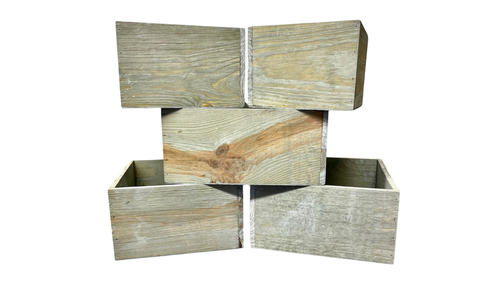 Pictured is a set of five weathered grey nested square planters.