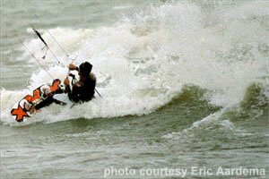 Eric kiteboarding on a wave