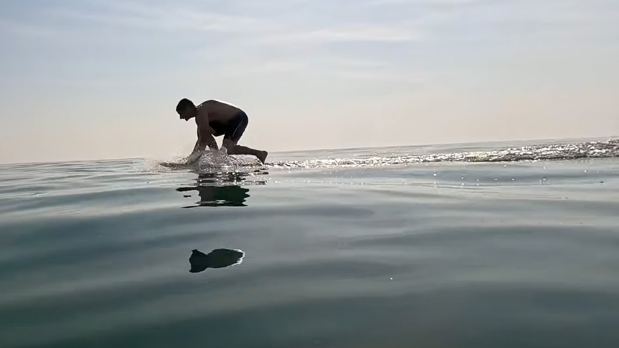 Matt starting to learn the Foil Drive by kneeling on the board