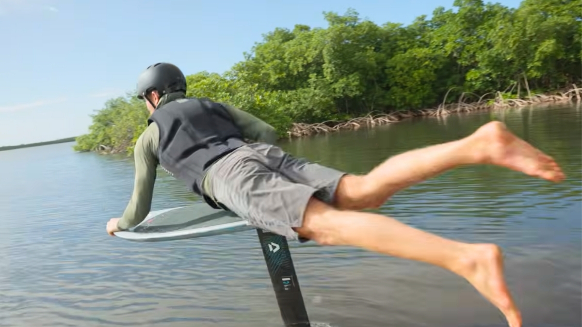 Rider practicing a belly start on a foil board during a pump foiling dockstart session