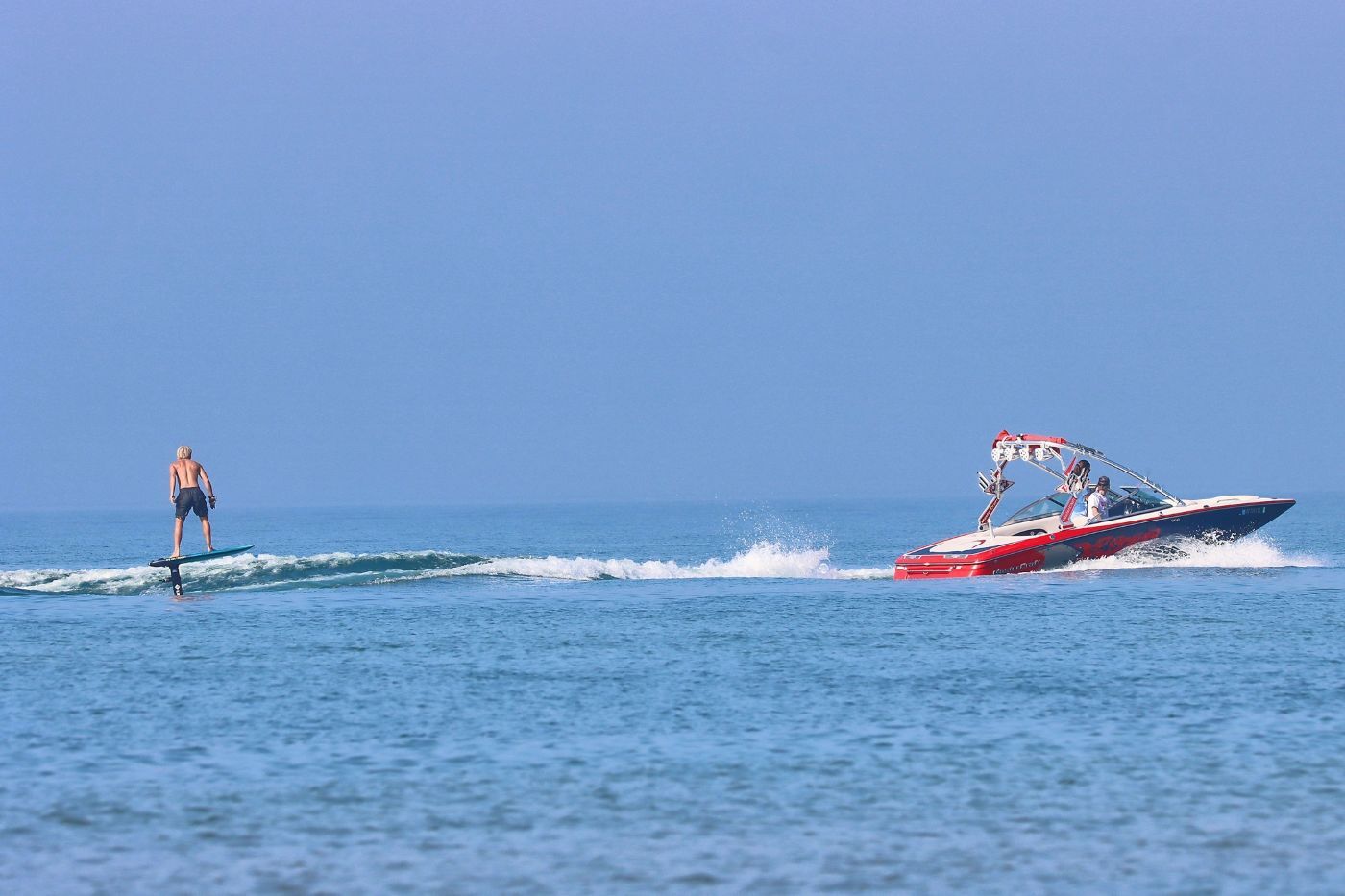 Hunter Lukes wakefoiling behind a Mastercraft Boat