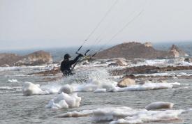 Andy Bolt kiteboarding in ice water in his drysuit