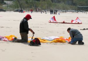 power foil kite set up- weighing down the kite with sand