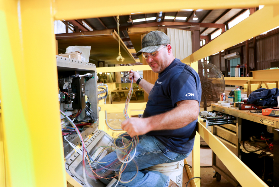 Ace Industries technician wiring a new overhead crane