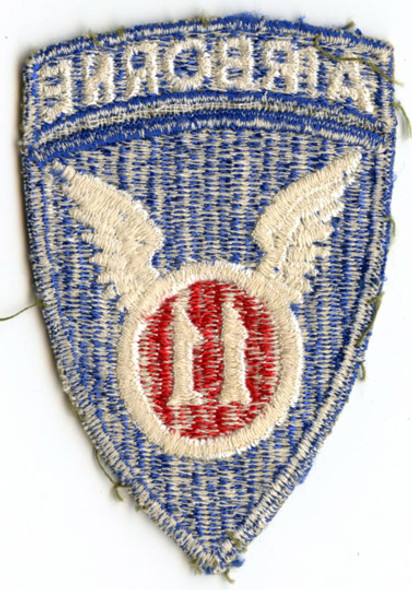 WWII US Army 11th Airborne Shoulder Patch with Integral Tab in Olive Drab Twill