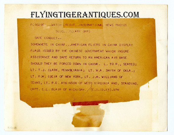 Great January 1943 Press Photo of USAAF Fighter Pilots Holding their Newly Issued Chinese Blood Chit